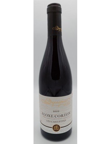 Une bouteille de vin rouge, debout, avec étiquette blanche et dorée et bouchon sombre.